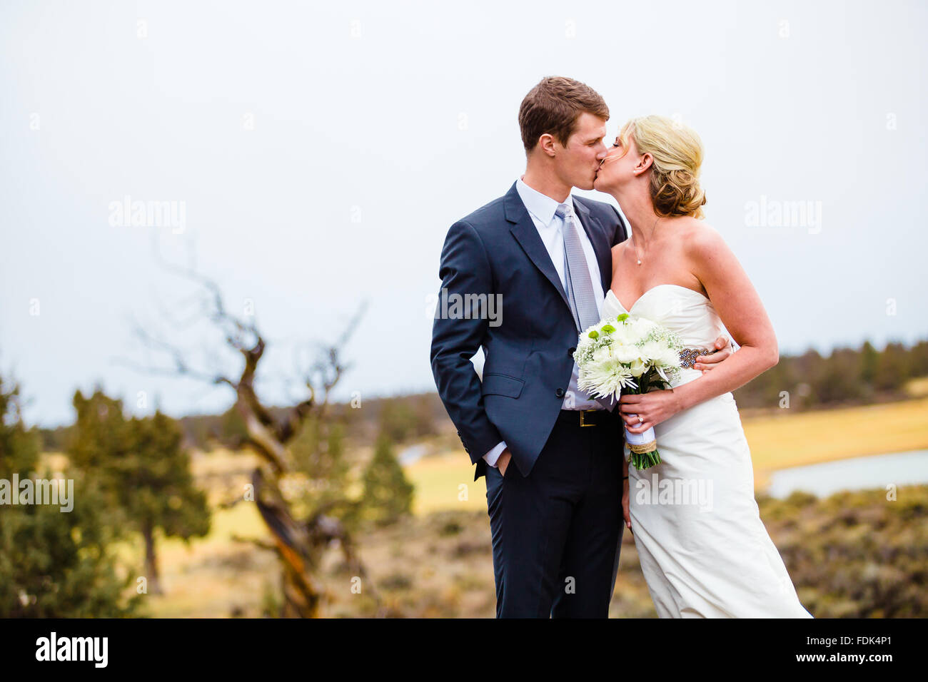 Bride and Groom Kissing outdoors Stock Photo - Alamy