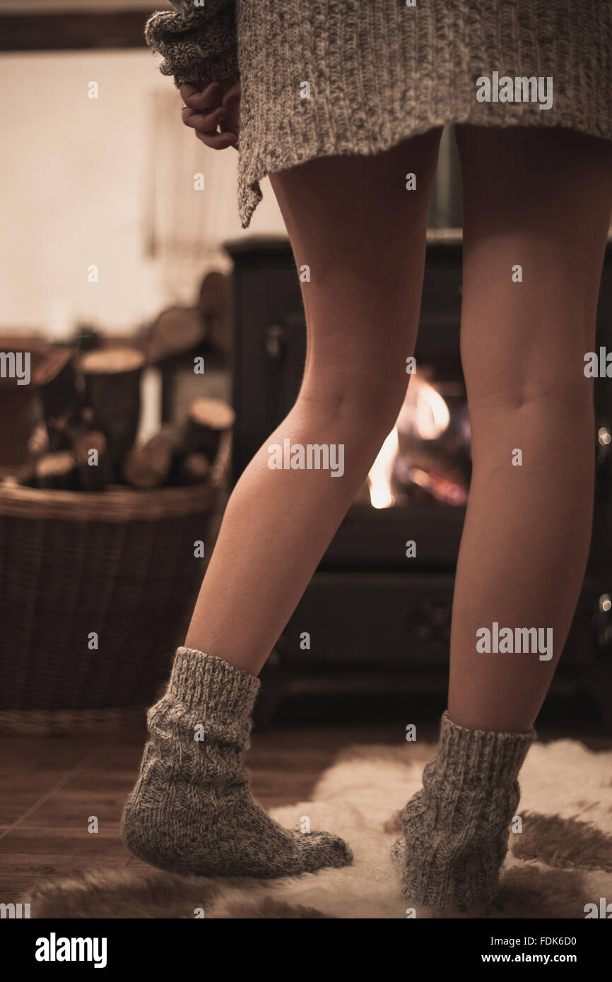 Woman standing in front of a wood burning stove Stock Photo Alamy