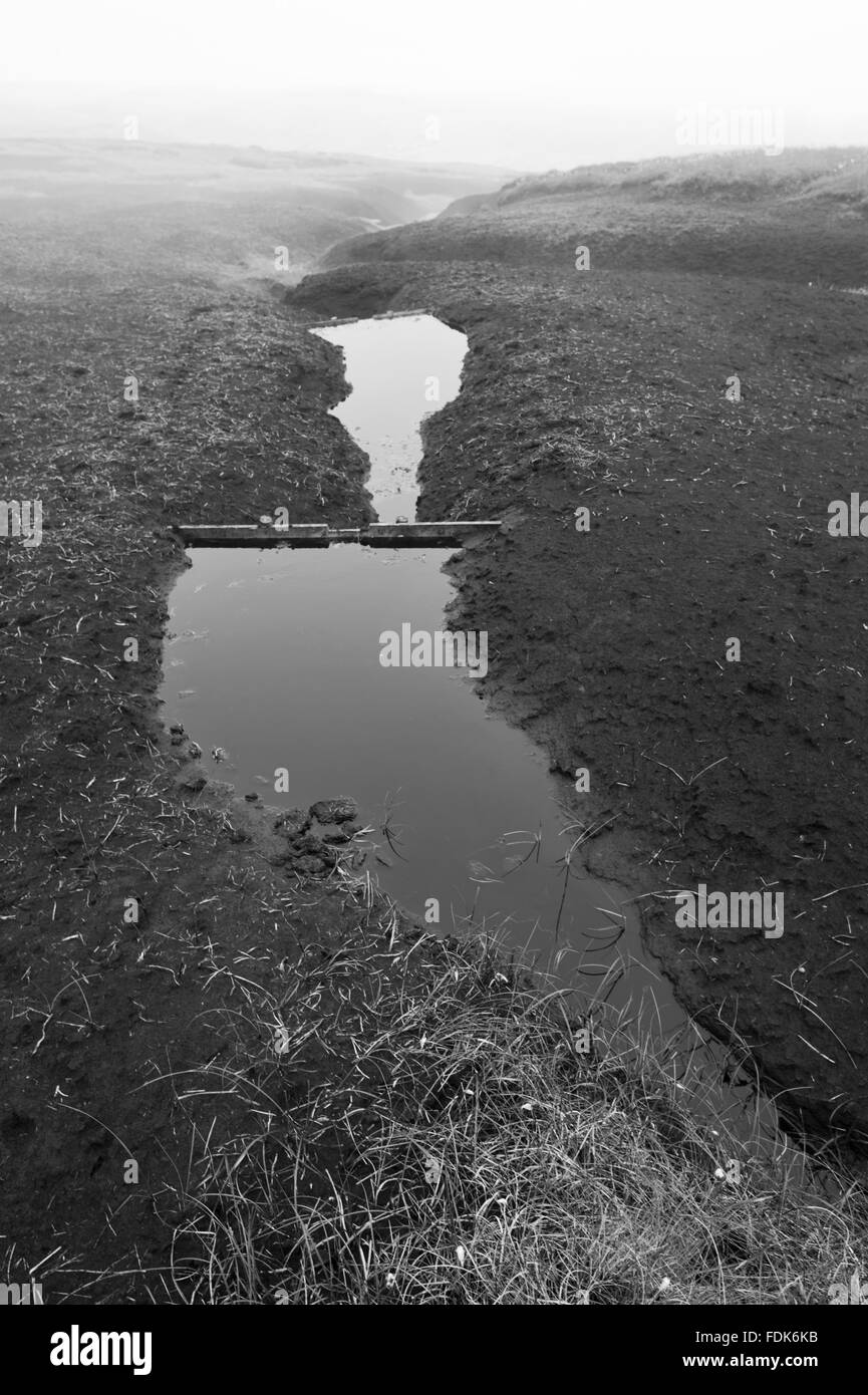 Black and white image of the blanket peat on the High Peak Estate, in the Peak District National Park, Derbyshire. The peatland is in poor condition and is undergoing significant erosion through pollution and earlier inefficient land management practices. Stock Photo