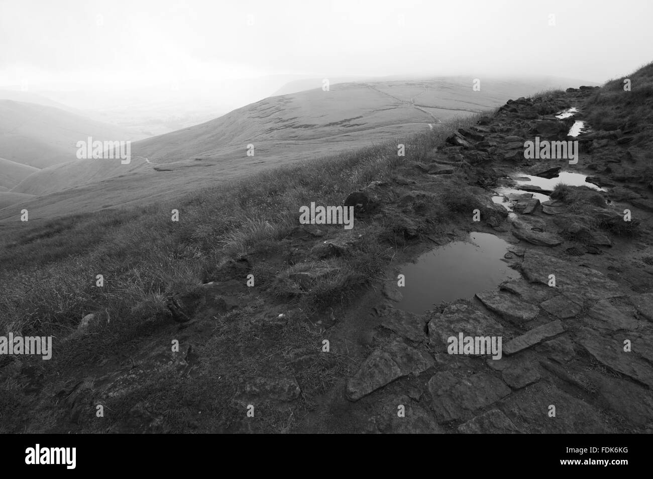 Black and white image of the rutted and worn footpath at Edale in the High Peak Estate, Derbyshire. Stock Photo