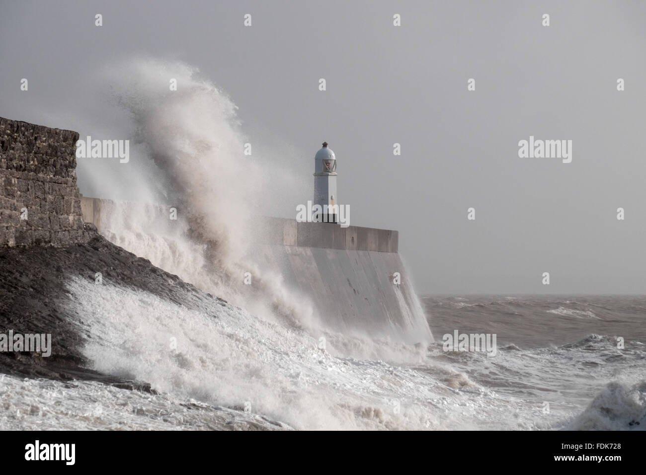 Porthcawl, Wales, UK. 1st February, 2016. Storm Henry brings widespread high winds sweeping across south Wales. Waves crash against Porthcawl lightouse and harbour wall. Credit:  Algis Motuza/Alamy Live News Stock Photo