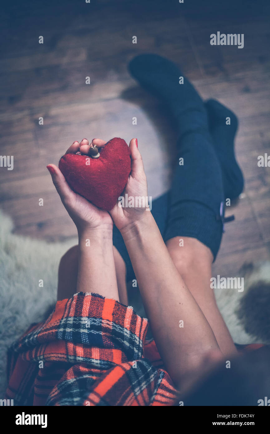 Woman holding a red heart in her hands Stock Photo - Alamy