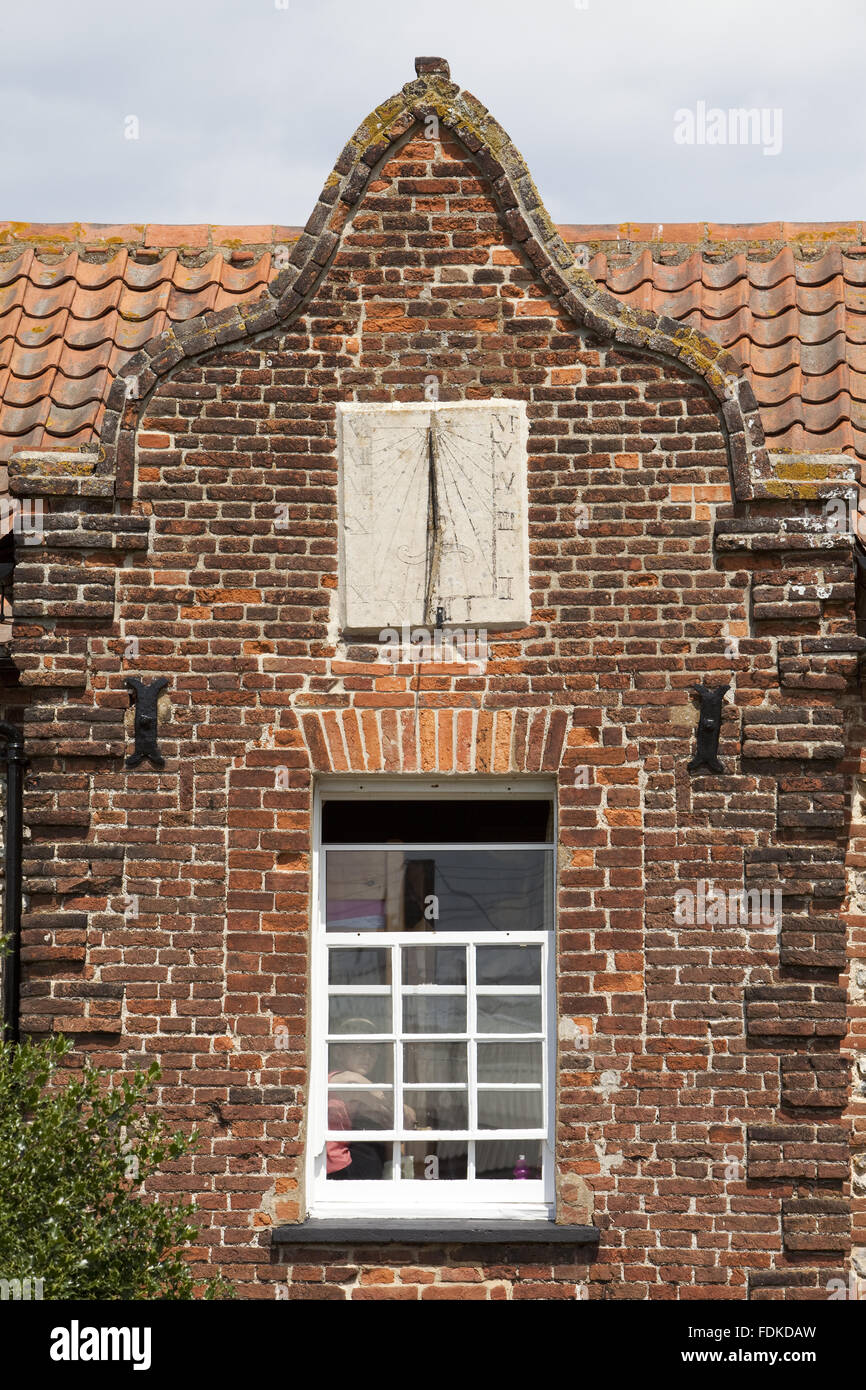 The sundial above a window at Brancaster Millennium Activity Centre, Norfolk. The 400-year-old Dial House is now a residential activity centre. Stock Photo