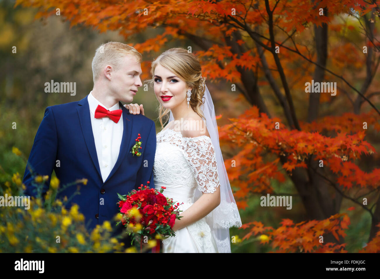 Portrait of the wedding couple in autumn forest Stock Photo