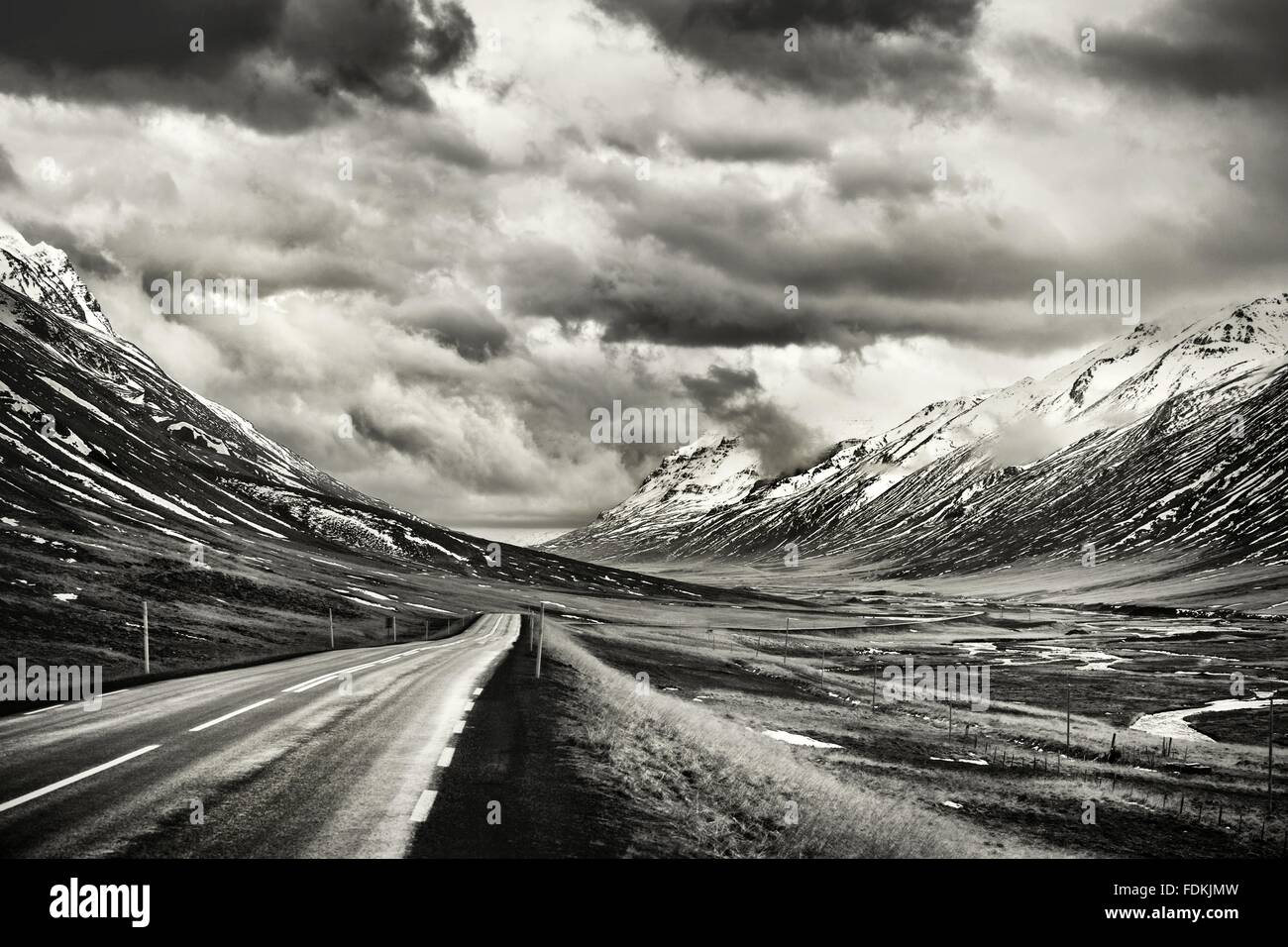 Icelandic road through glacial valley in Oxnadalur.  Shot in black and white for effect. Stock Photo