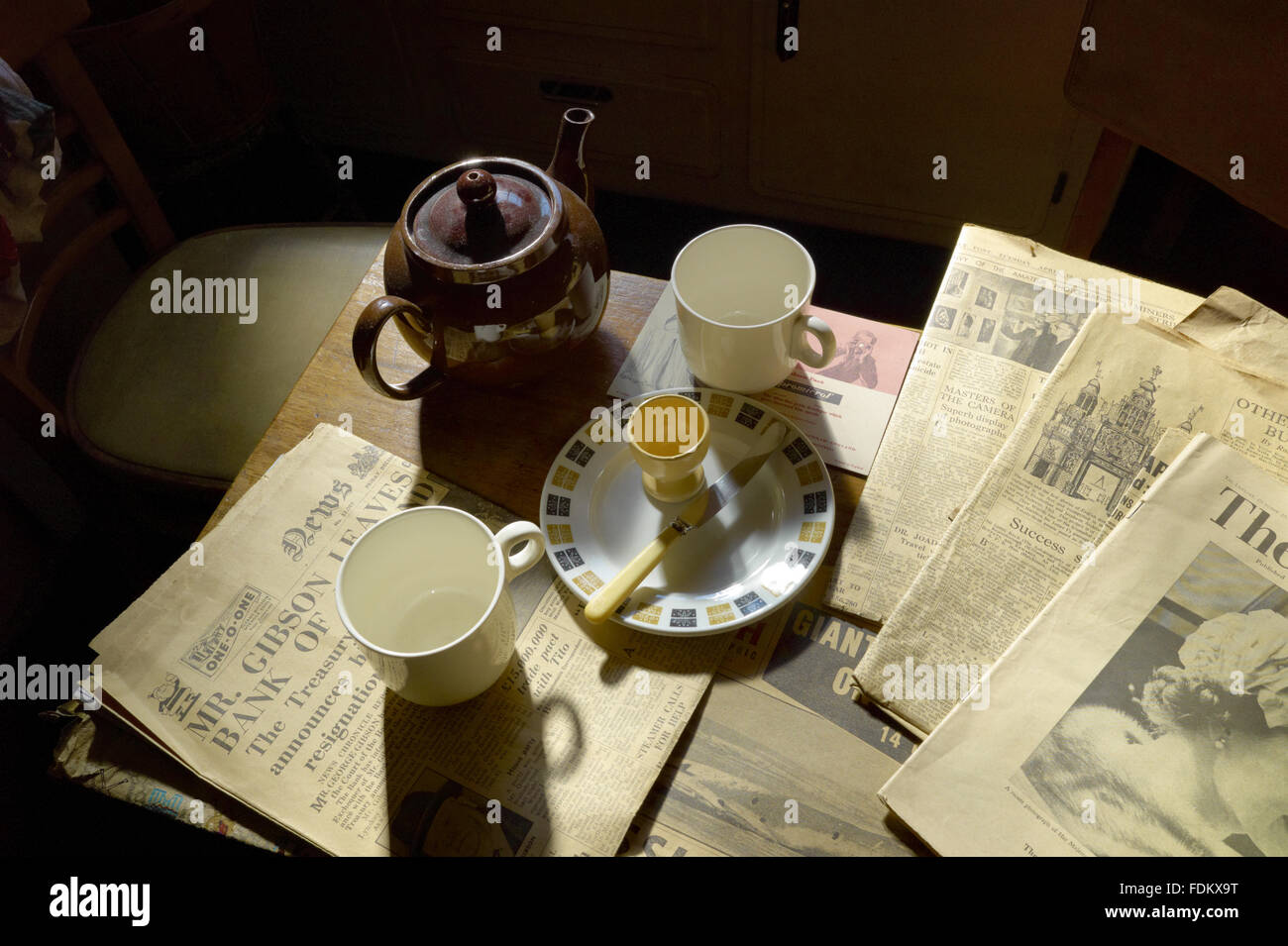 Breakfast crockery and newspapers on a table in the Kitchen at The Hardmans' House, 59 Rodney Street, Liverpool. Stock Photo