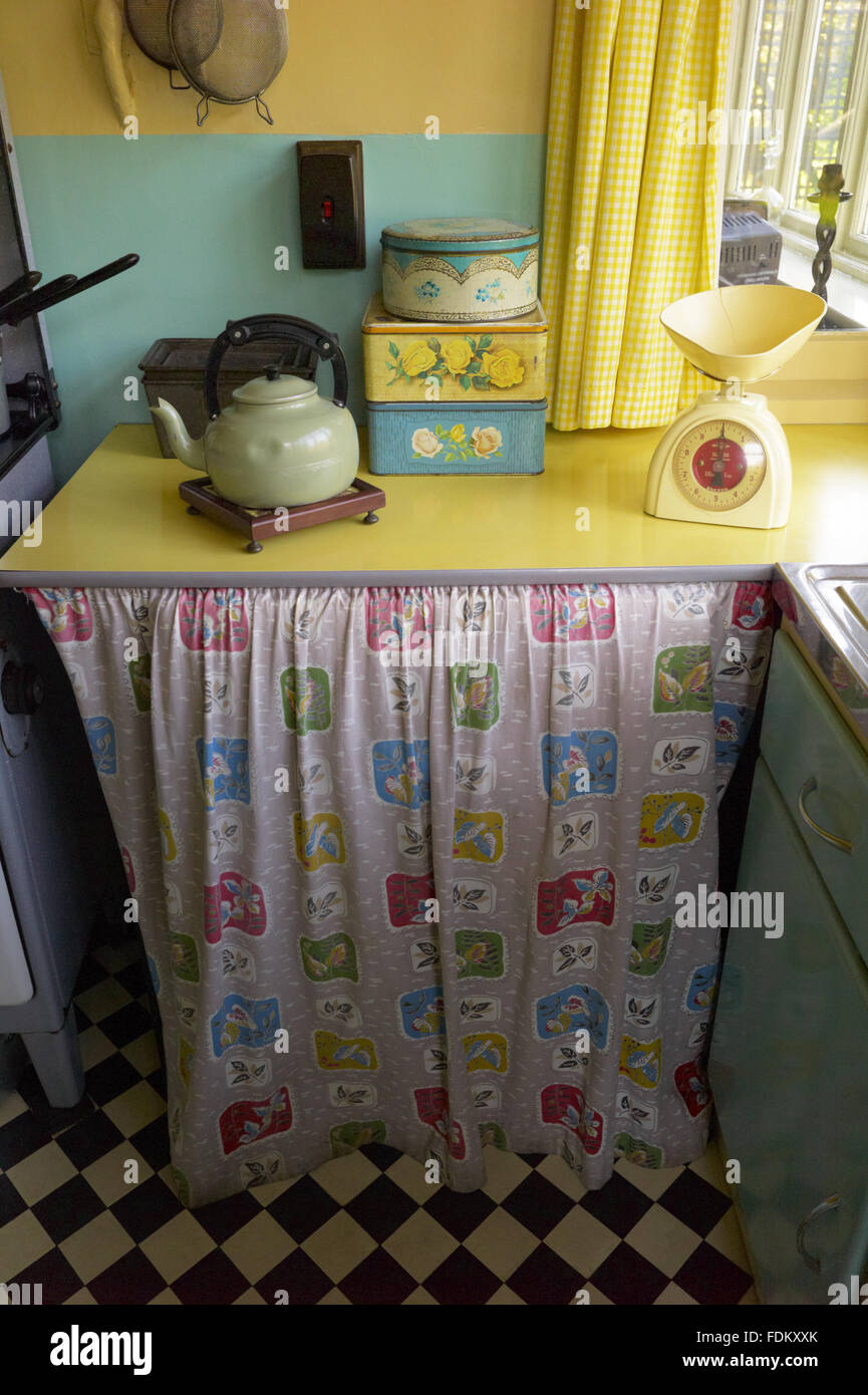 Kettle and tins on a work surface with a curtain below in the Kitchen at Mendips, the childhood home of John Lennon, in Woolton, Liverpool. Stock Photo