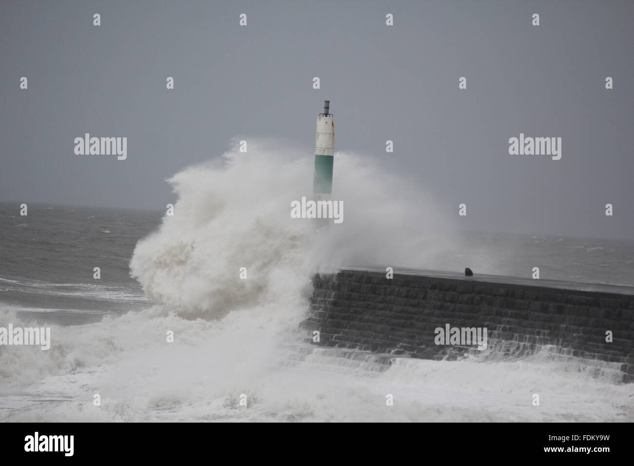 Aberystwyth Wales UK, 2016, huge waves driven by gale force winds continue to batter the sea defences of Wales & western regions Stock Photo