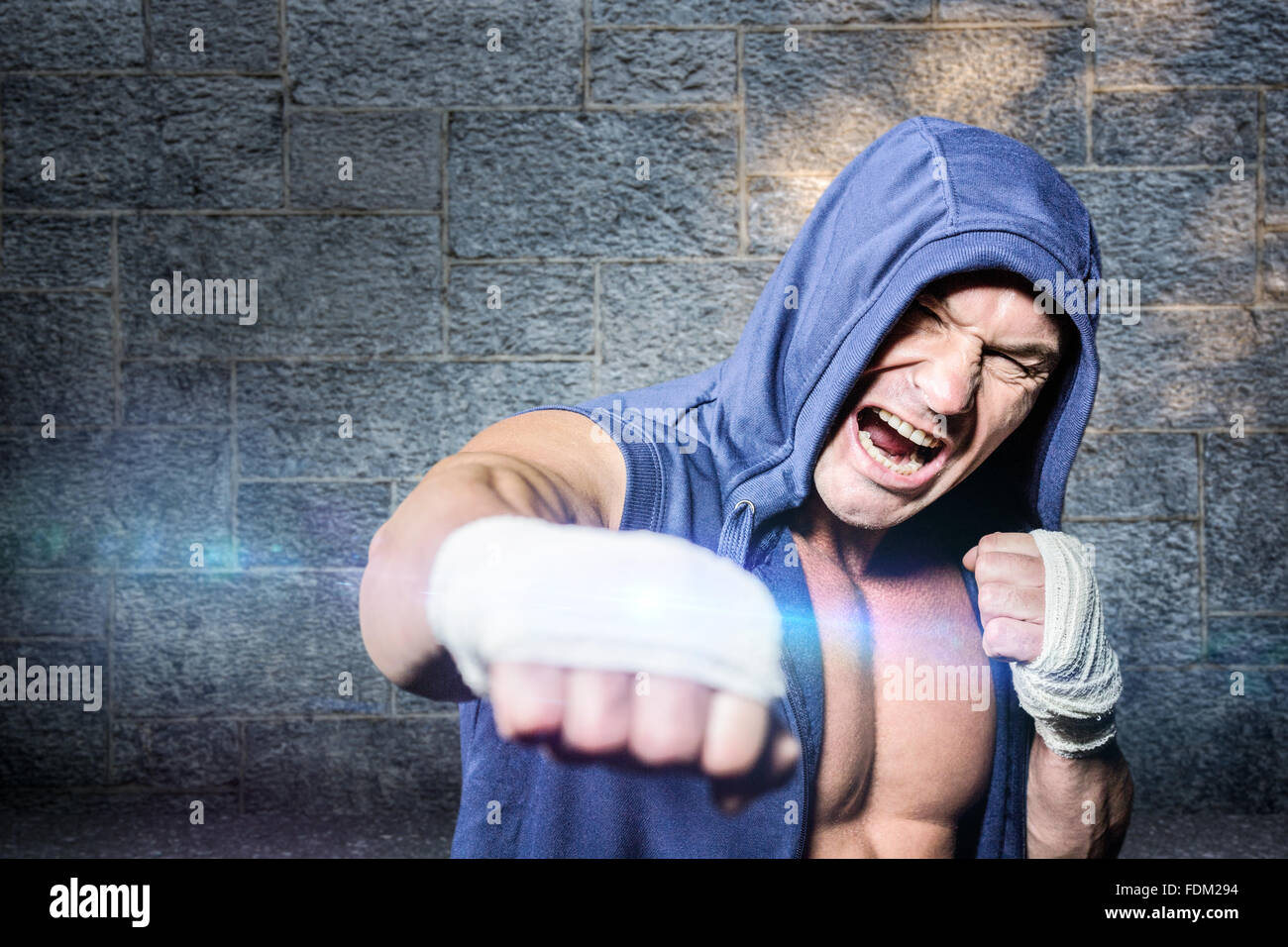 Composite image of aggressive fighter punching against black background ...
