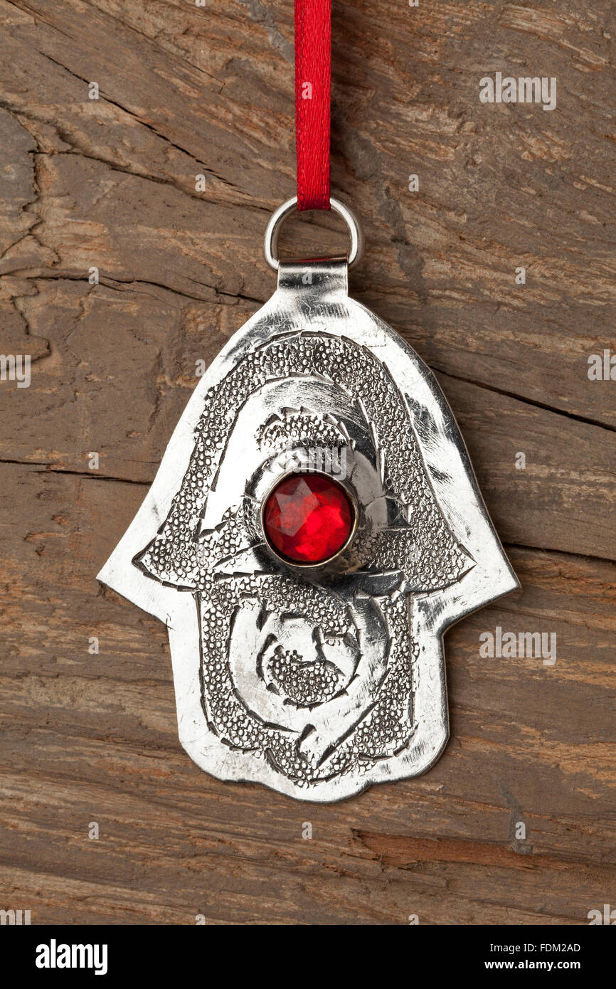 Hand of Fatima amulet hanging on a wooden wall Stock Photo