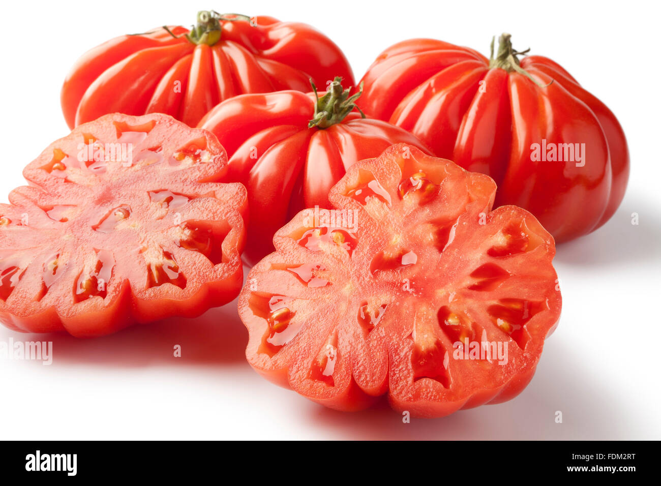 Fresh organic whole and half Rebellion tomatoes closeup on white background Stock Photo