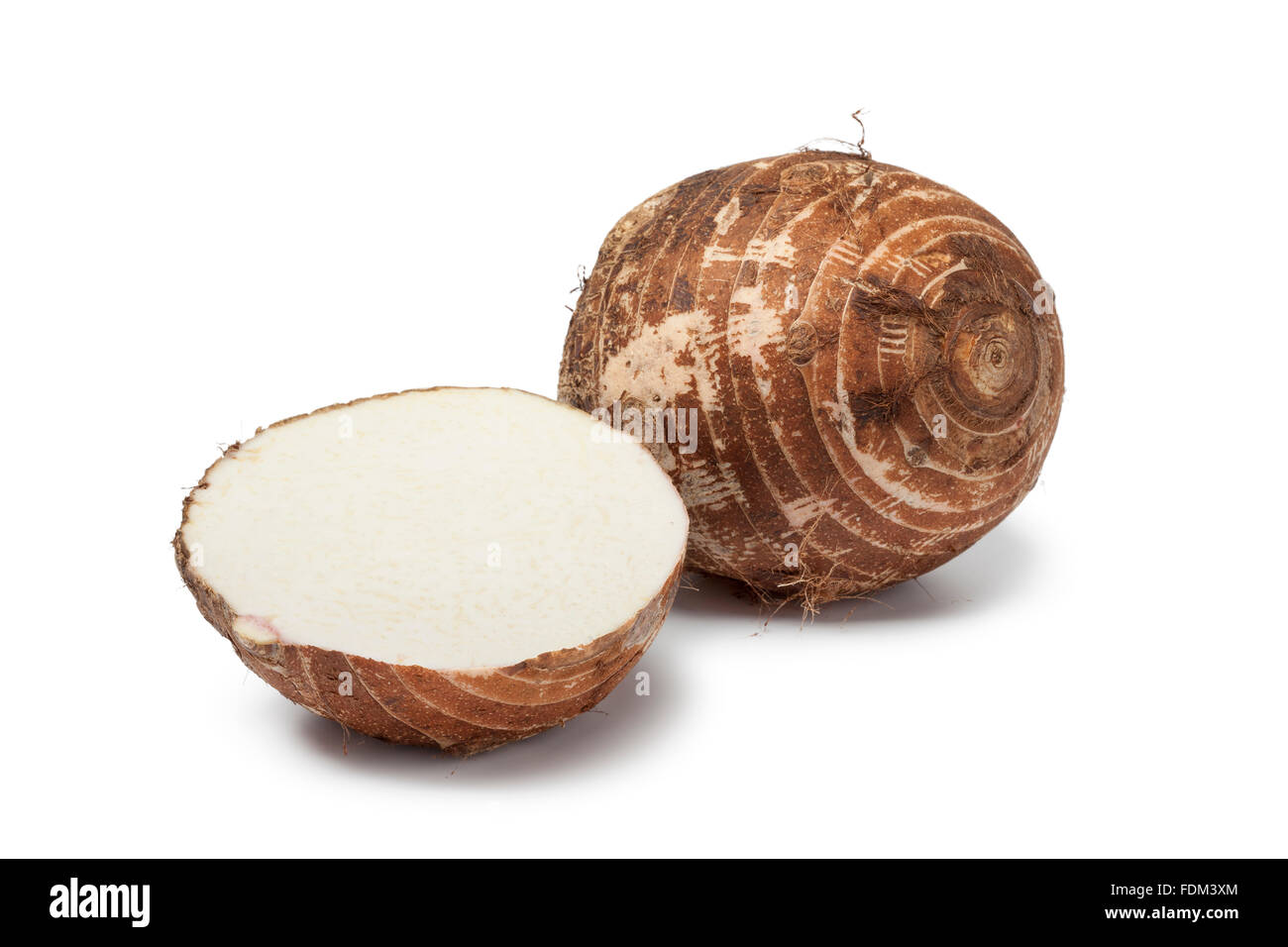 Whole and half fresh Chinese taro roots on whiet background Stock Photo