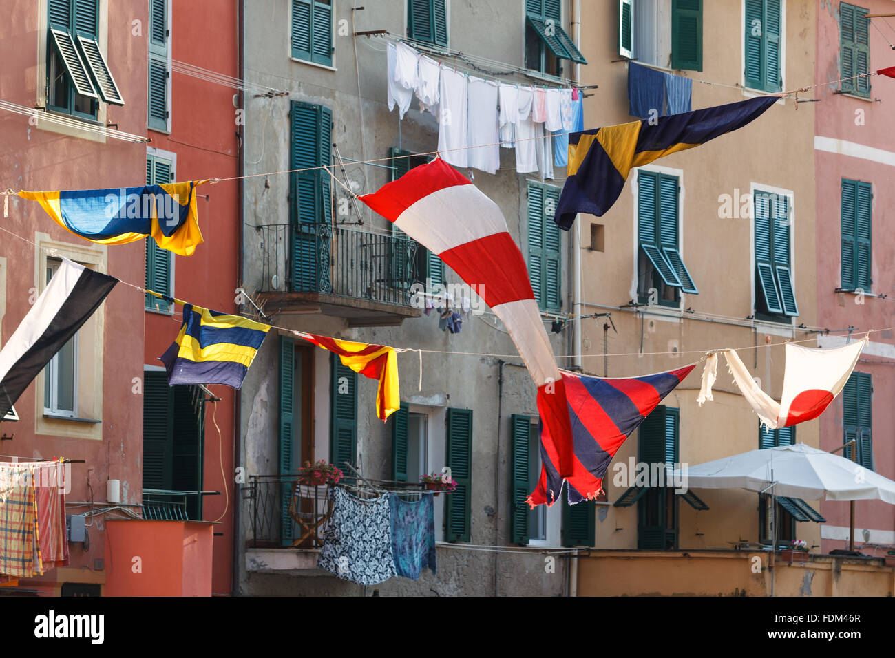 Some flags and balconies and window in Vernazza, Cinque Terre (Five Lands) National Park, Liguria, Italy. Stock Photo
