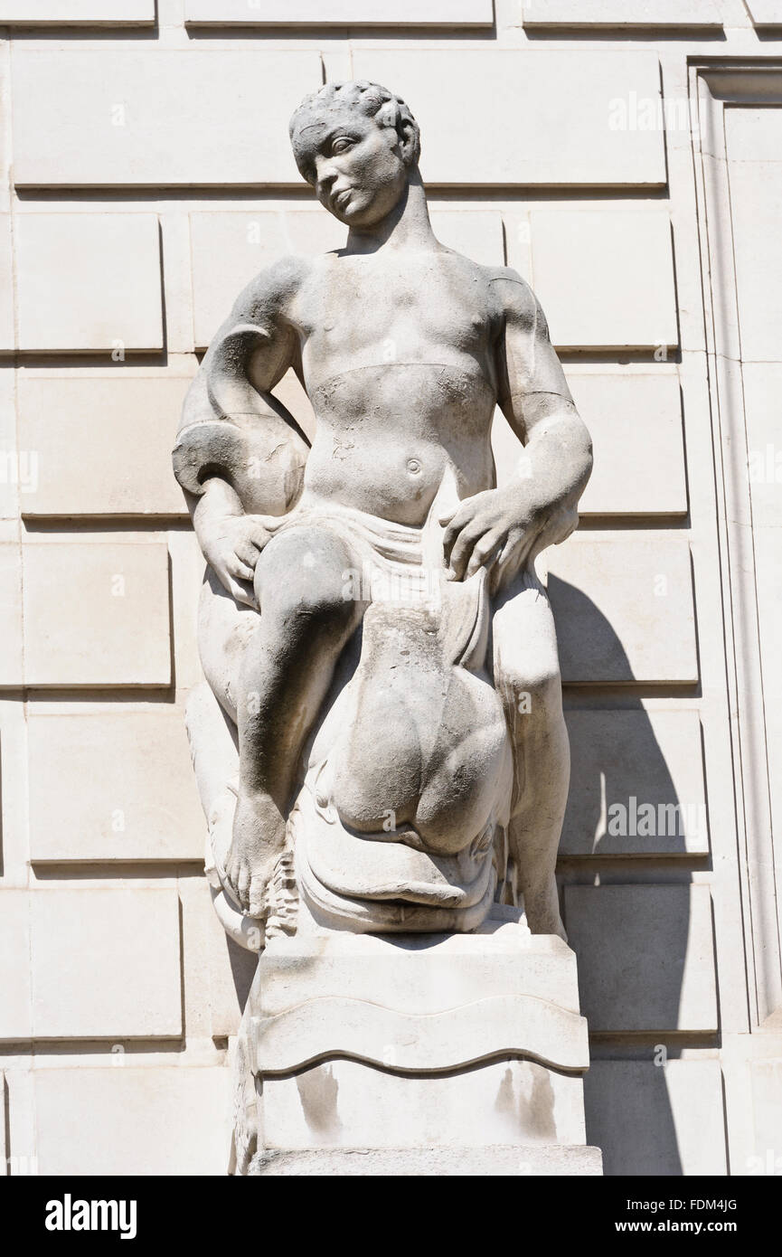 Decorative statue on the wall of Department of Energy and Climate Office building, London, United Kingdom. Stock Photo