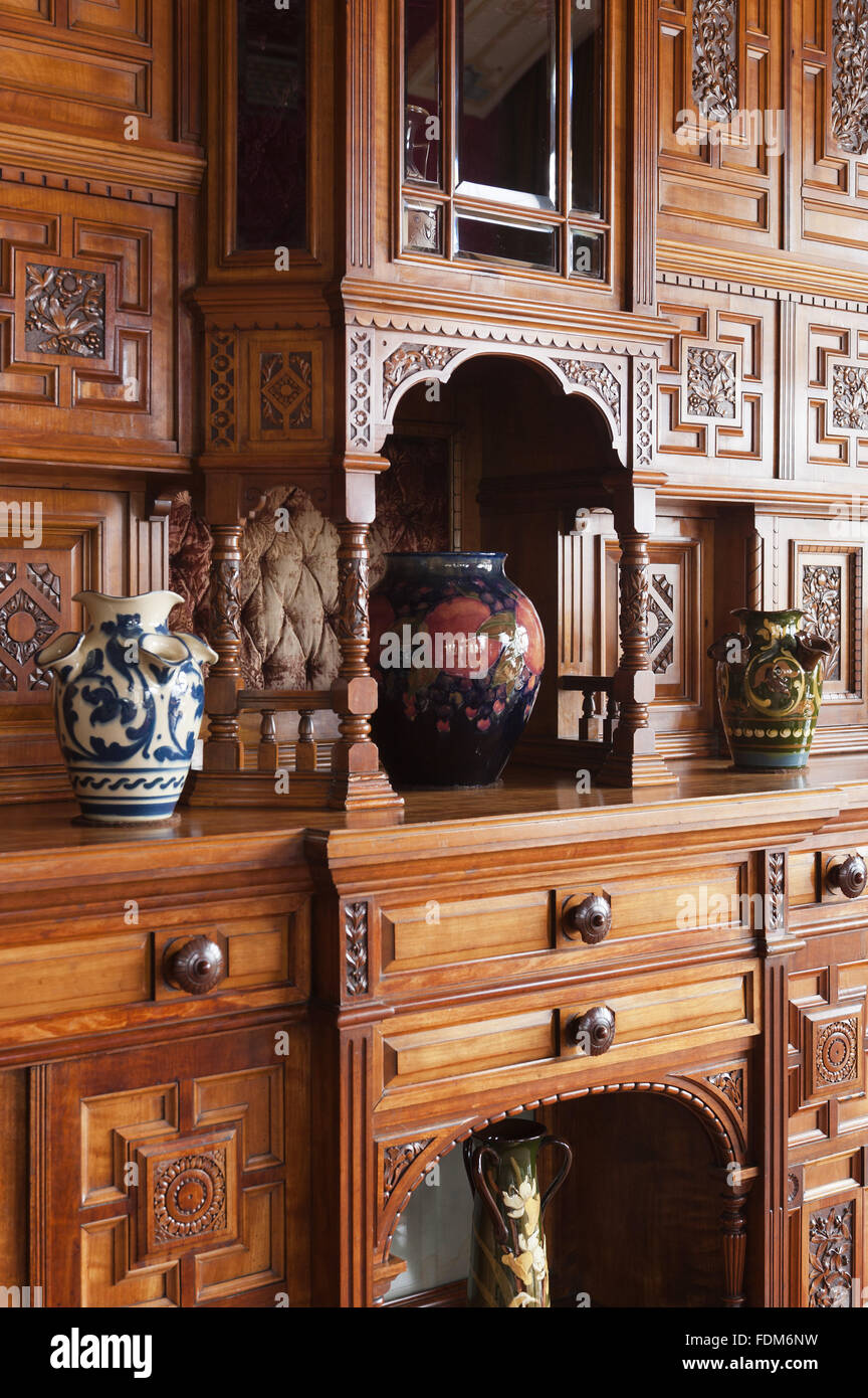 Cabinet in the Drawing Room at Knightshayes Court, Devon. The cabinet was designed by HW Batley and made by Henry Ogden & Son around 1878. NT inventory number: 540726. Stock Photo
