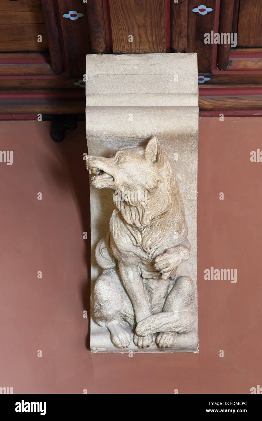 Stone corbel in the Billiard Room at Knightshayes Court, Devon. The seven corbels in the room depict animals representing the Seven Deadly Sins; here the wolf is Anger. Stock Photo