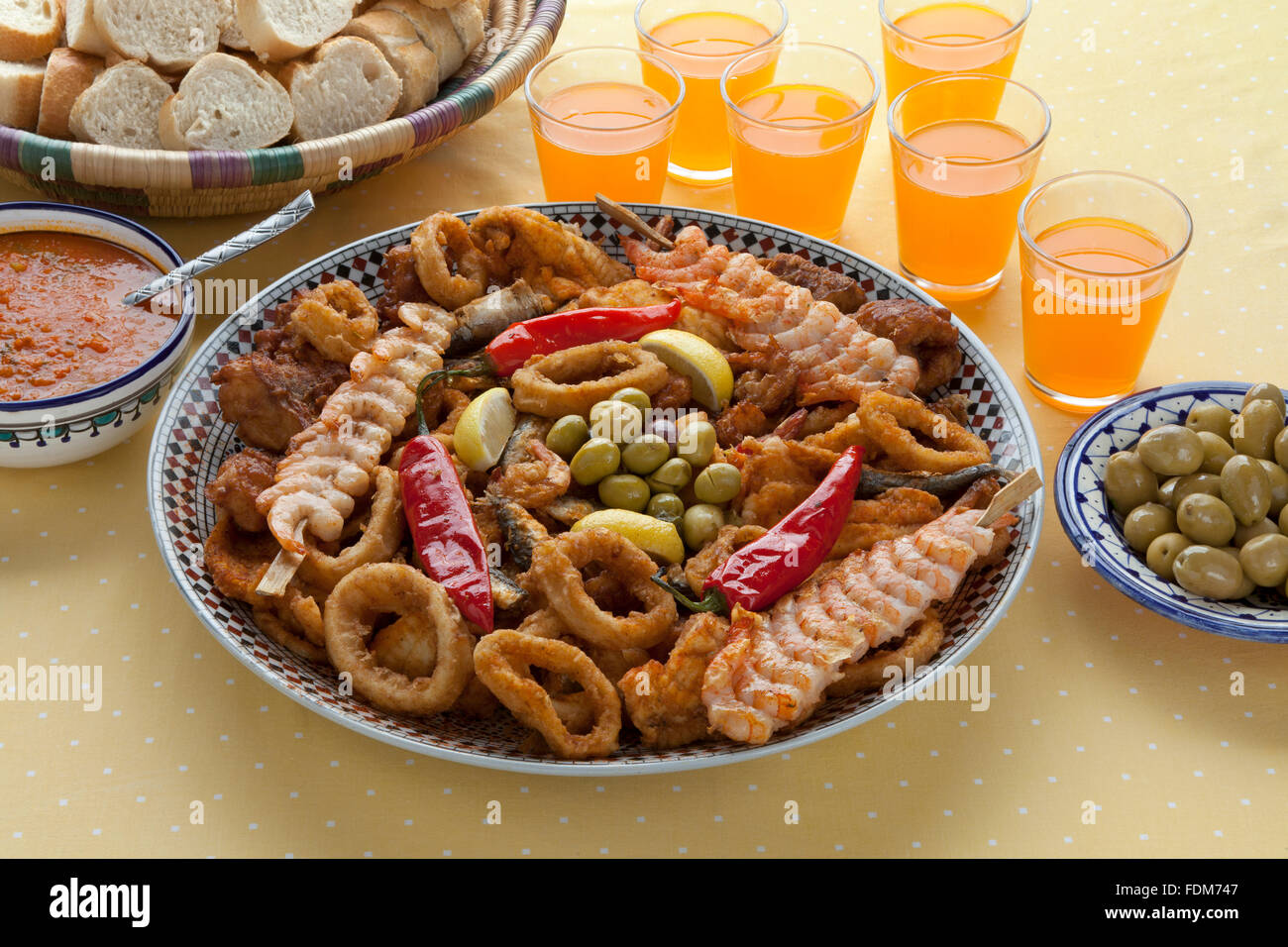 Traditional Moroccan fish dish with sauce,olives and bread Stock Photo