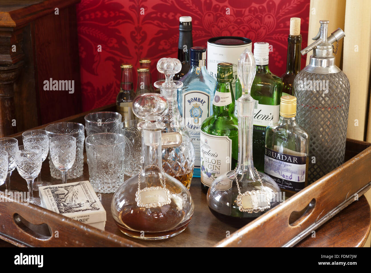 The drinks tray with glass decanters and bottles in the Saloon at Coughton Court, Warwickshire. Stock Photo