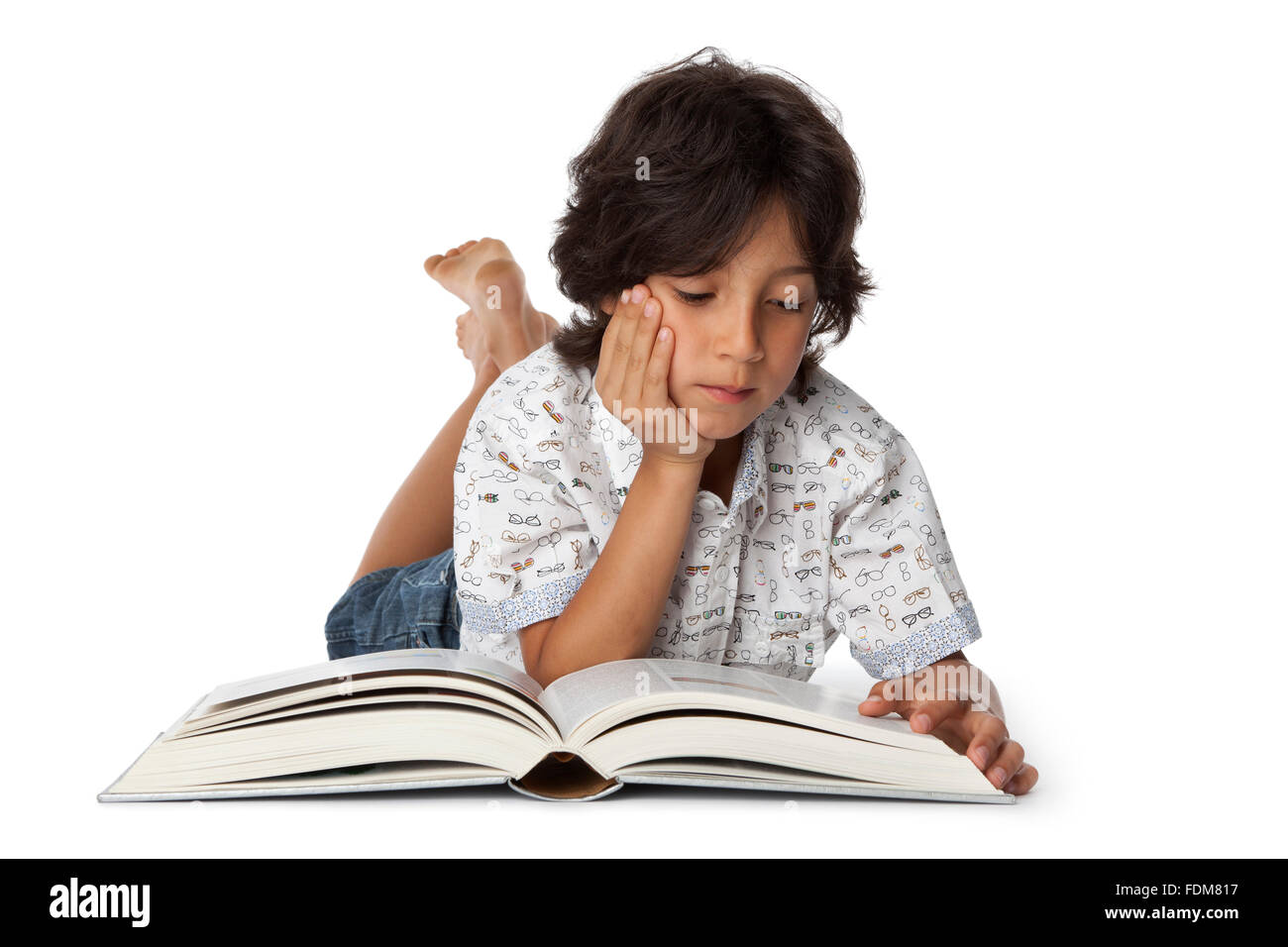 Little boy is reading a book on white background Stock Photo