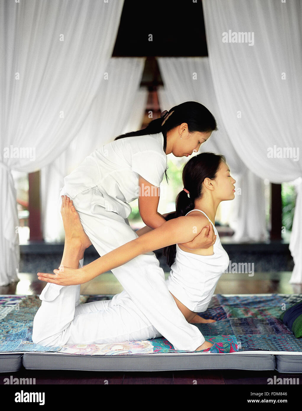 A Filipina woman receives a Thai massage in San Benito, Philippines. Stock Photo
