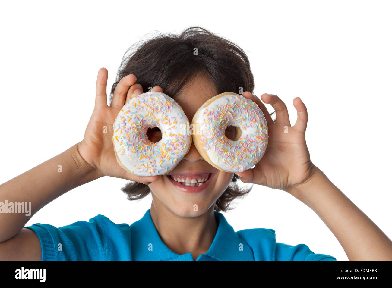 Little boy making fun with donuts on white background Stock Photo