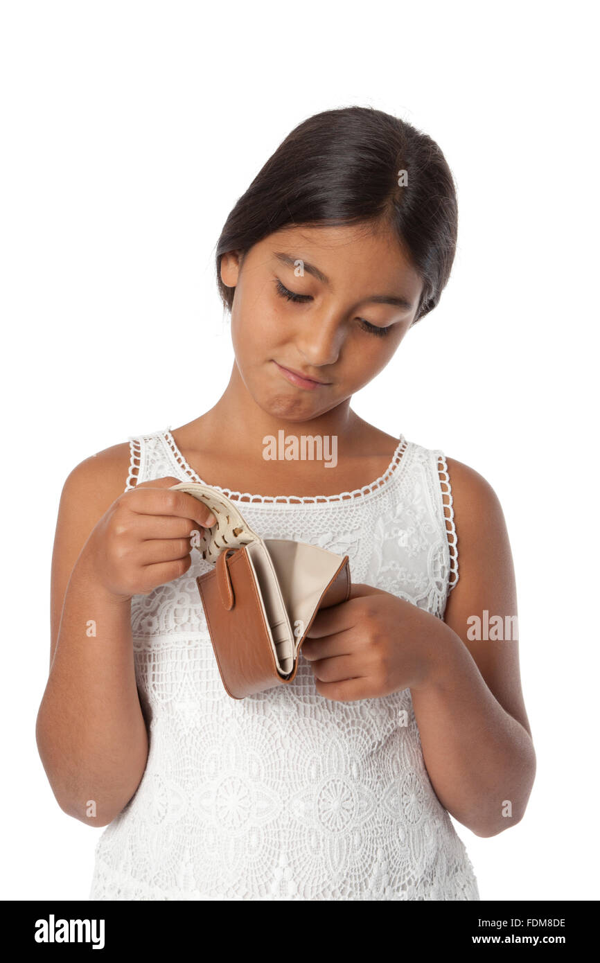Young broke teenage girl looking into her empty wallet on white background Stock Photo