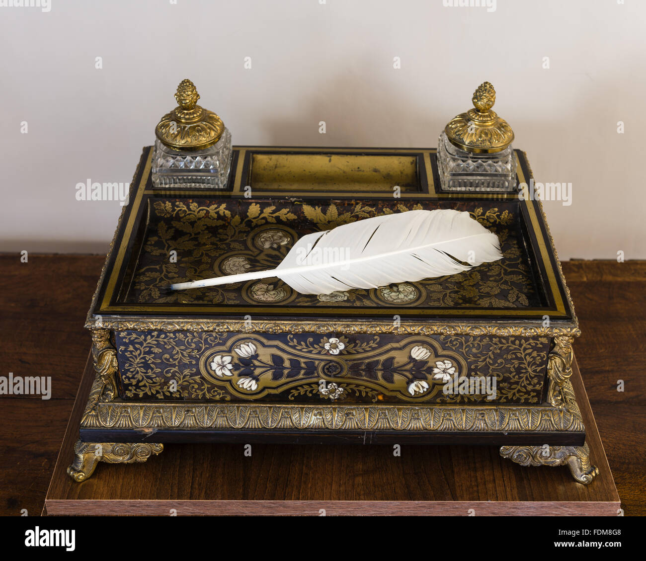 An inkstand and quill pen in the Exhibition Room at Coleridge Cottage, Somerset. NT Inventory number: 253291. The Boulle inkstand belonged to the poet Coleridge when he lived in Highgate. Coleridge Cottage was the home of Samuel Taylor Coleridge between 1 Stock Photo