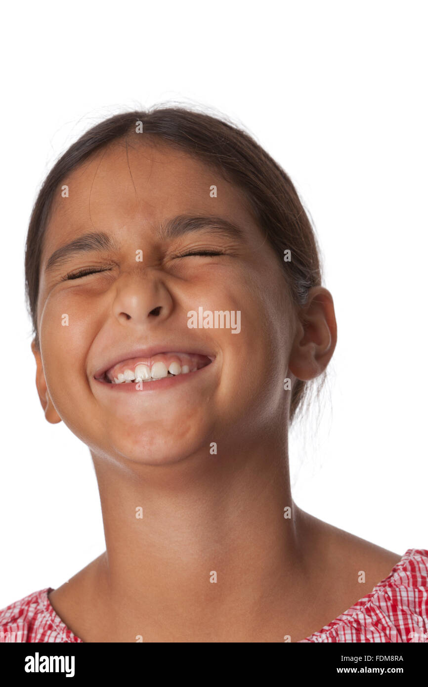 Young teenage girl closing eyes with excitement, portrait on white background Stock Photo