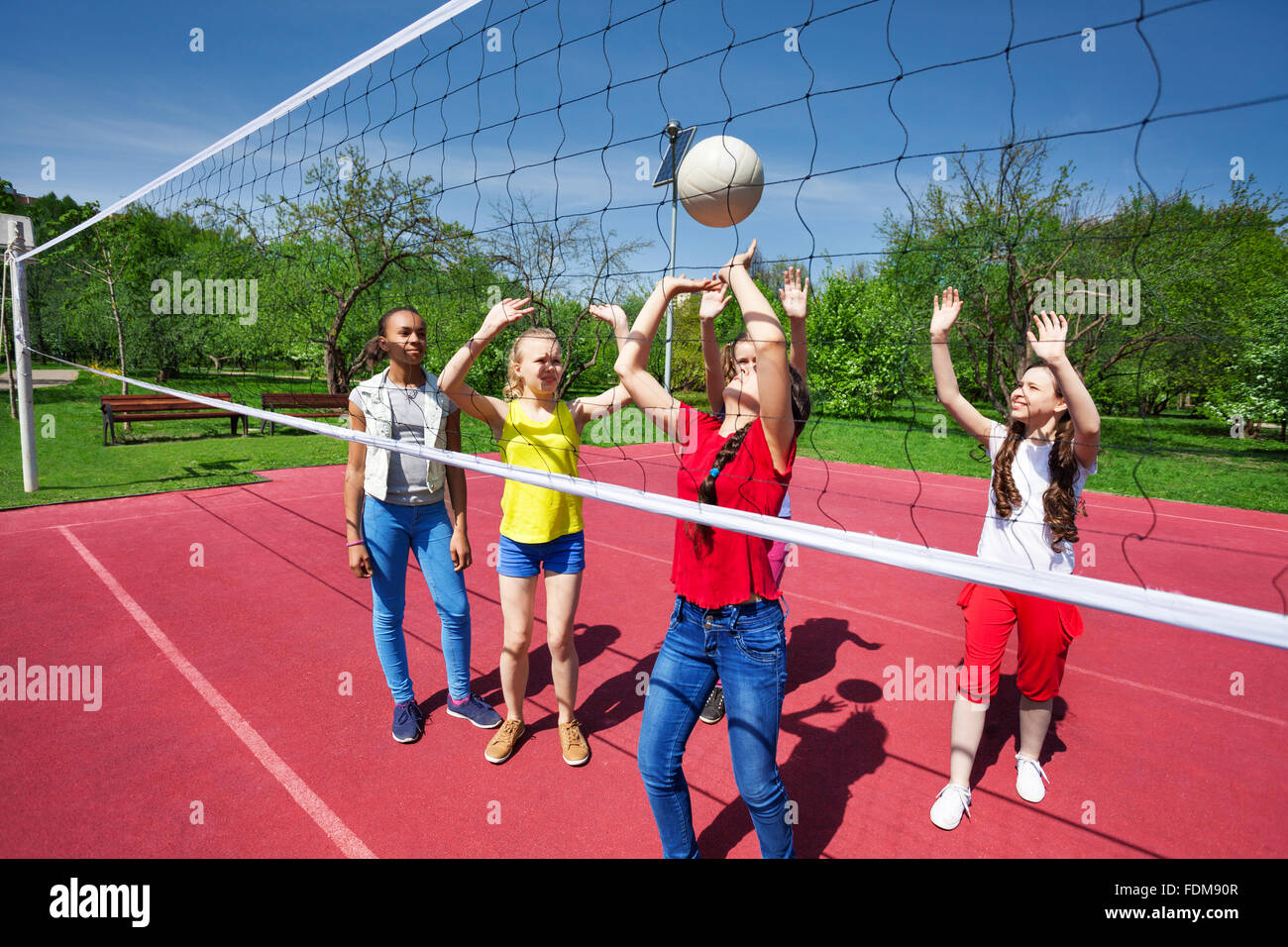 Teens play during volleyball game on playground Stock Photo Alamy