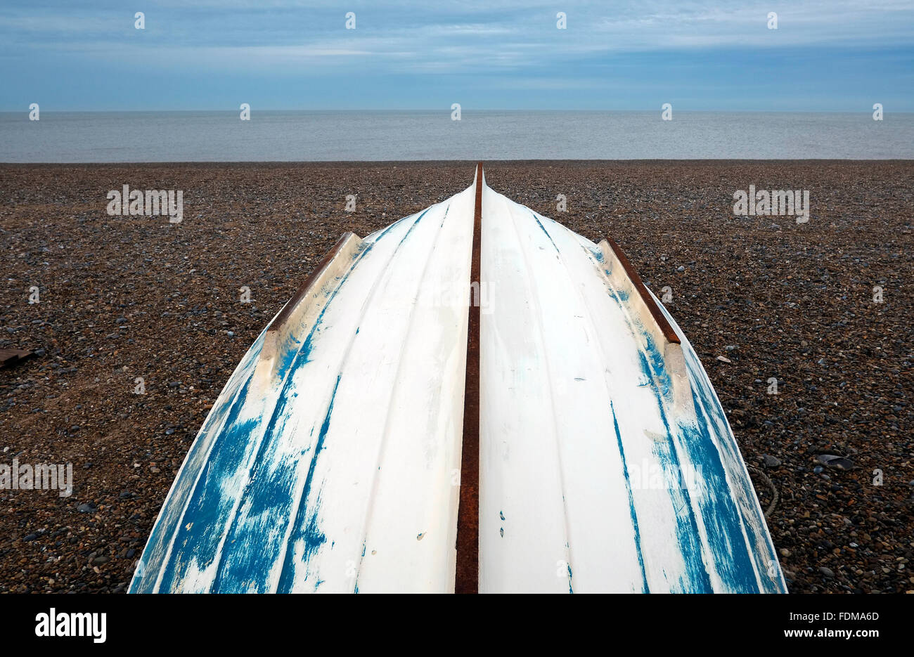 upturned white boat on cley beach, north norfolk, england Stock Photo