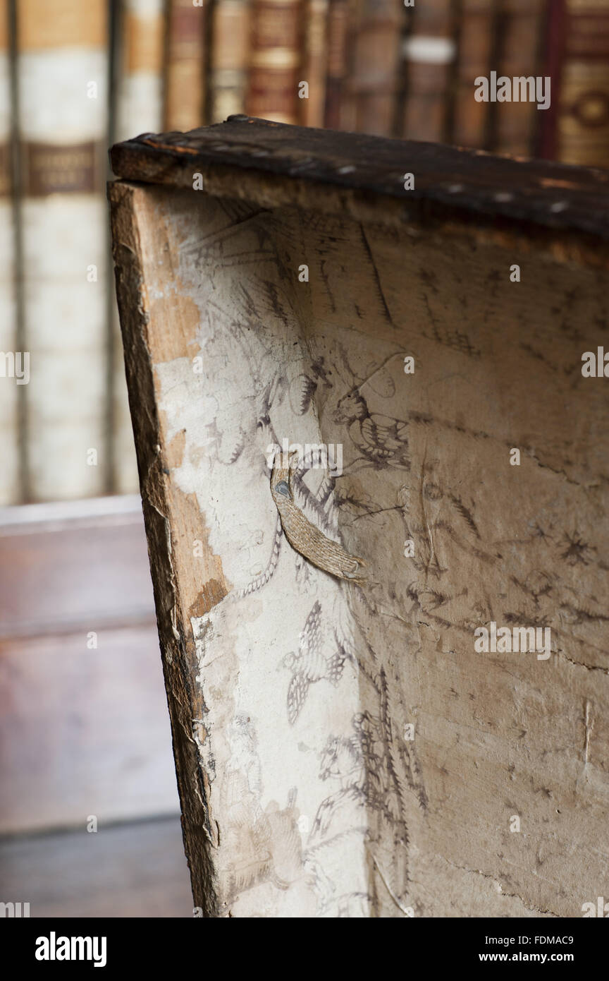 The inside of a trunk lined with paper from 1735, in the Library at Dunham Massey, Cheshire. Stock Photo