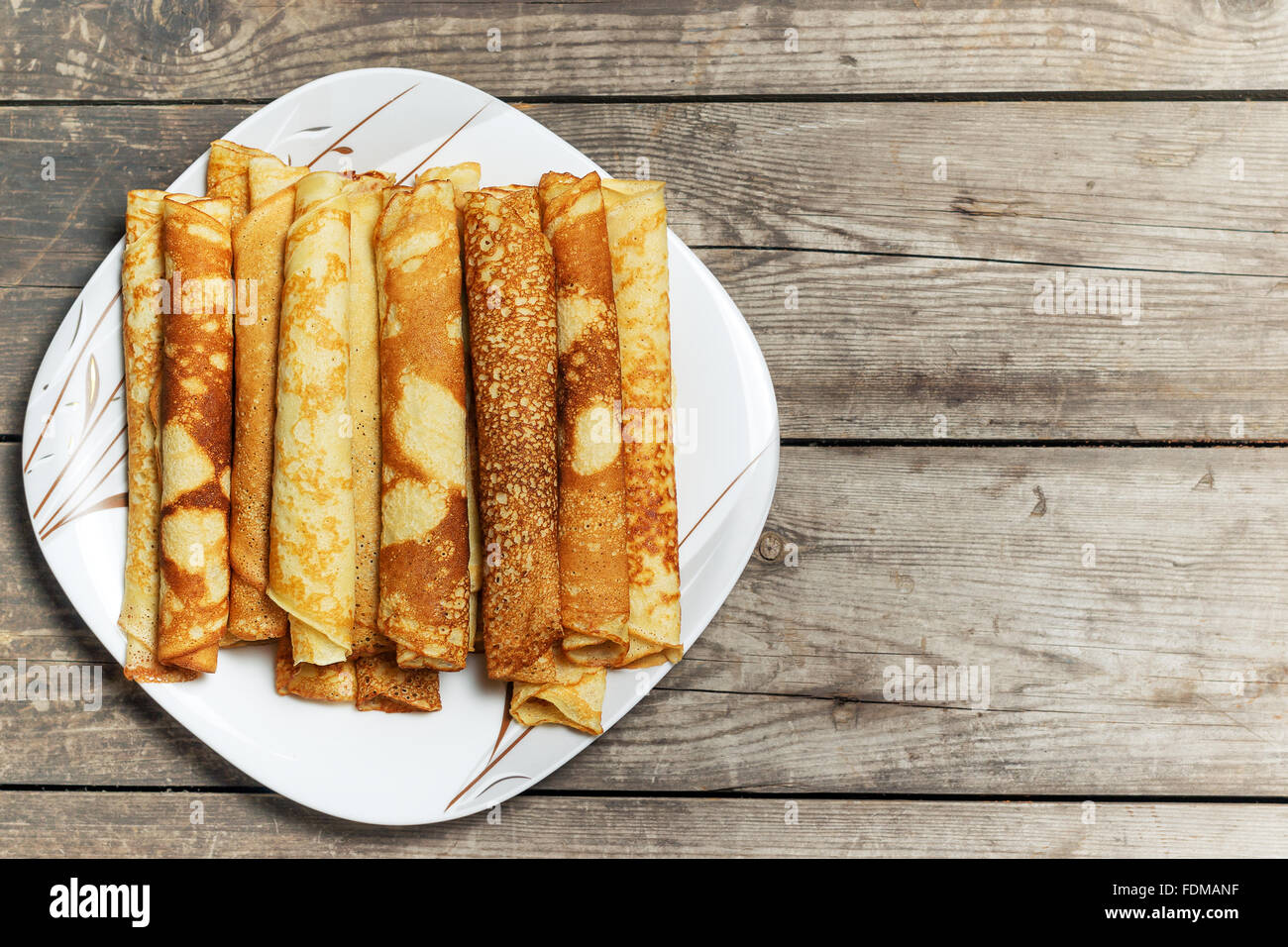 Roasted rolled pancakes on a square plate. Top view . Stock Photo