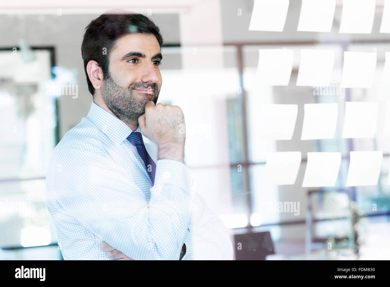 Young businessman in office looking at the notes Stock Photo - Alamy