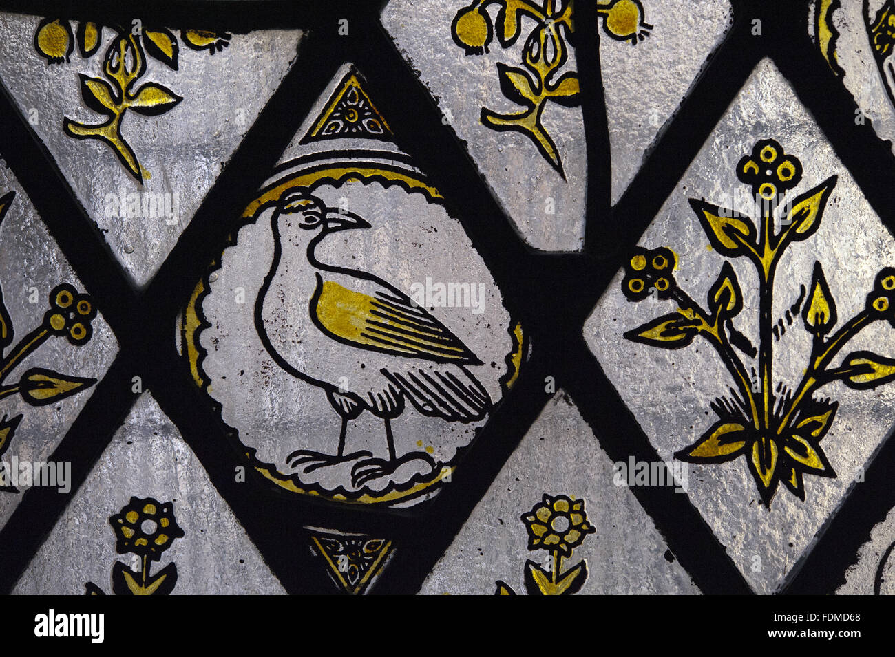 A section of the Victorian painted glass window looking into the inner courtyard from outside the Butler's Outer Pantry at Tyntesfield, Somerset. Stock Photo