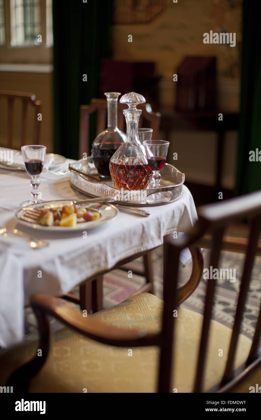 Decanters and food on the dining table in the Governor's Dining Room at Avebury Manor, Wiltshire. Stock Photo