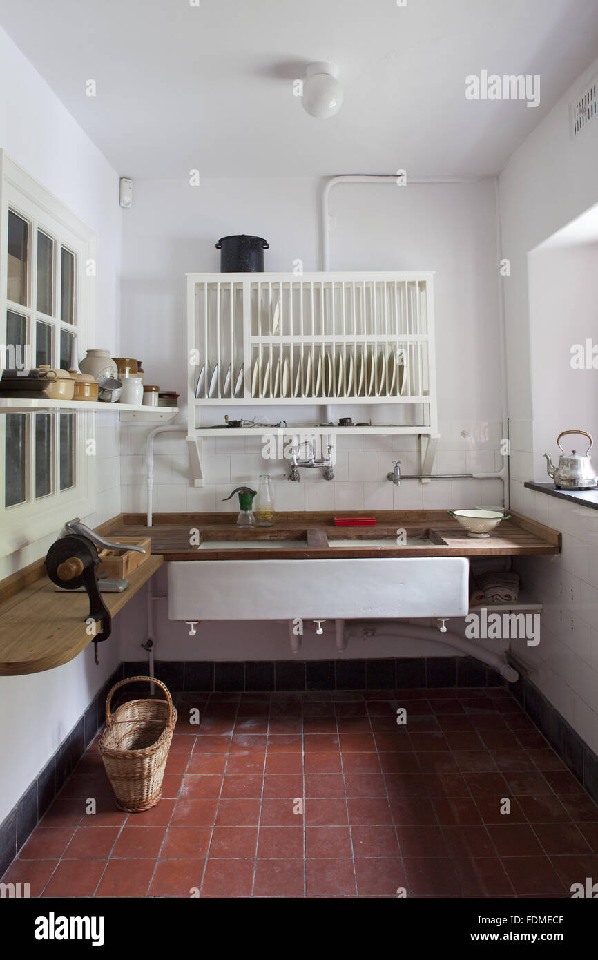 The sink with plate rack above in the Kitchen at Coleton Fishacre, Devon. Stock Photo