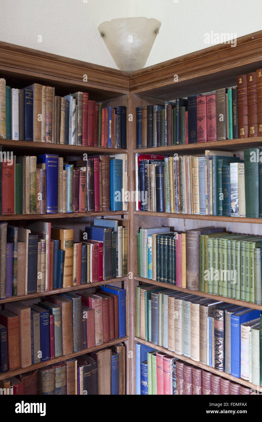 Bookshelves in the Library at Coleton Fishacre, Devon. Stock Photo
