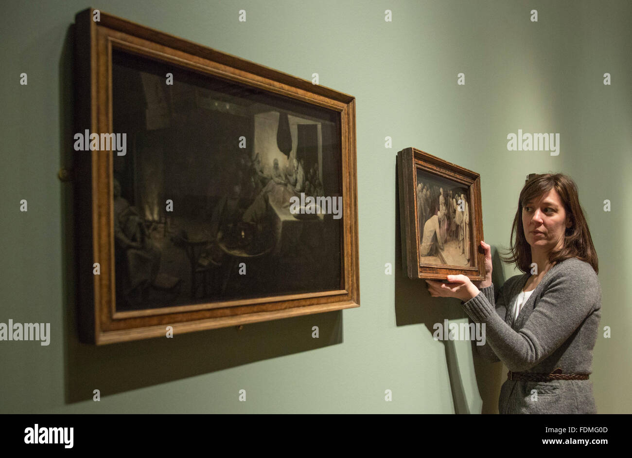 London, UK. 1 February 2016. A Courtauld Gallery employee holds the Bruegel painting Christ and the Woman Taken in Adultery, 1565. Bruegel in Black and White: Three Grisailles Reunited at The Courtauld Gallery. From 4 February to 8 May 2016 Pieter Bruegel the Elder’s three surviving grisaille paintings will be shown together for the first time at The Courtauld Gallery. The three panels will be accompanied by comparative prints and contemporary replicas, alongside other independent grisailles to examine their legacy and the development of this genre in Northern Europe. Stock Photo