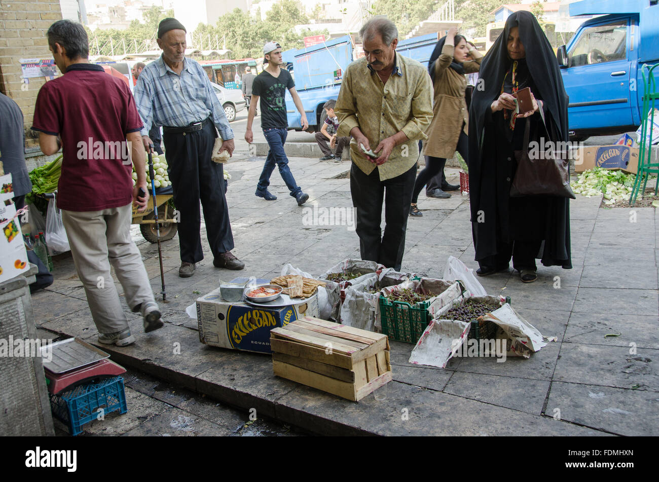 Old man selling Sour Cherries in Tajrish bazaar, Tehran, Iran Stock Photo