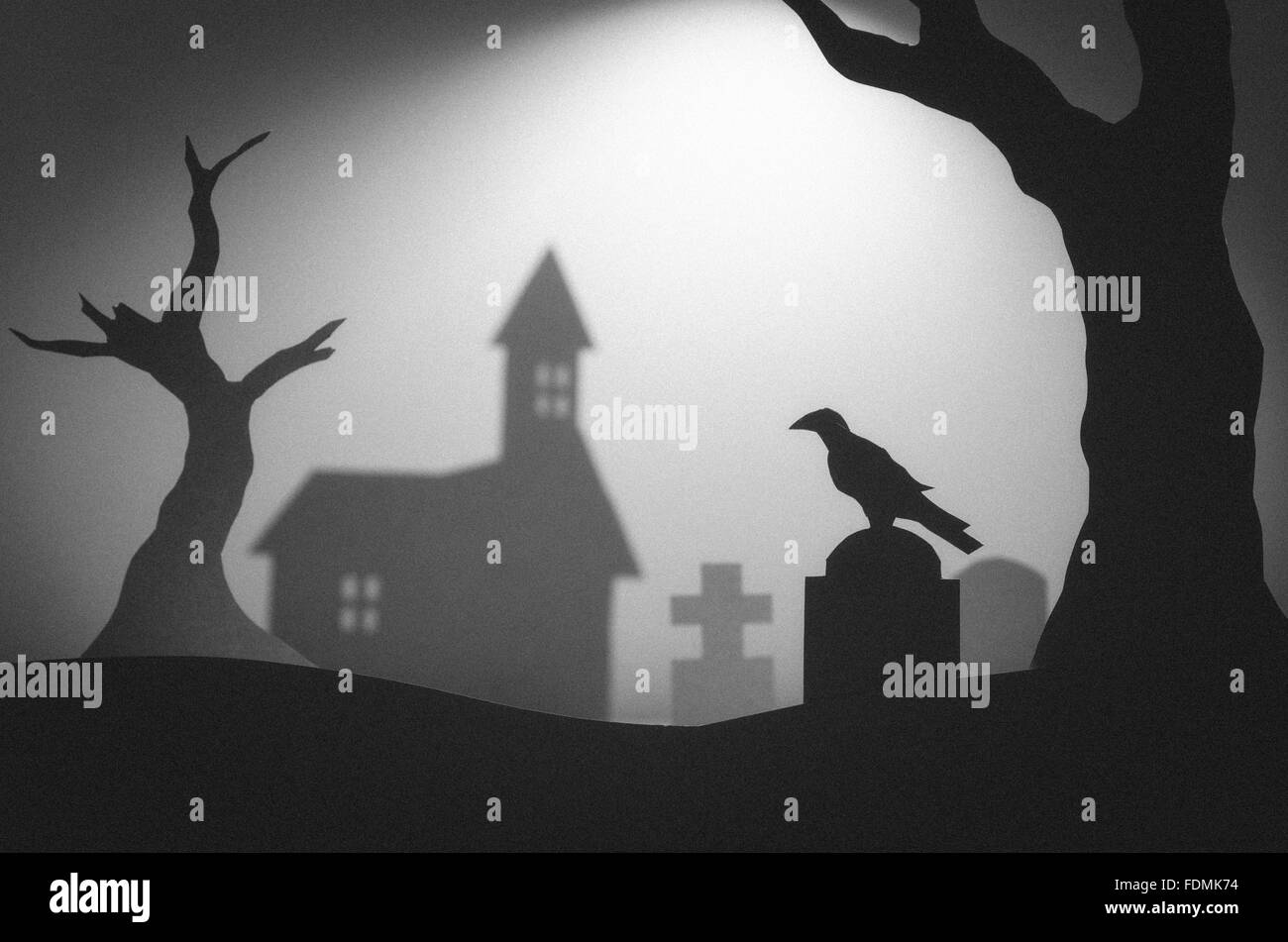 Halloween night in haunted dark graveyard with tombstones, raven and trees Stock Photo