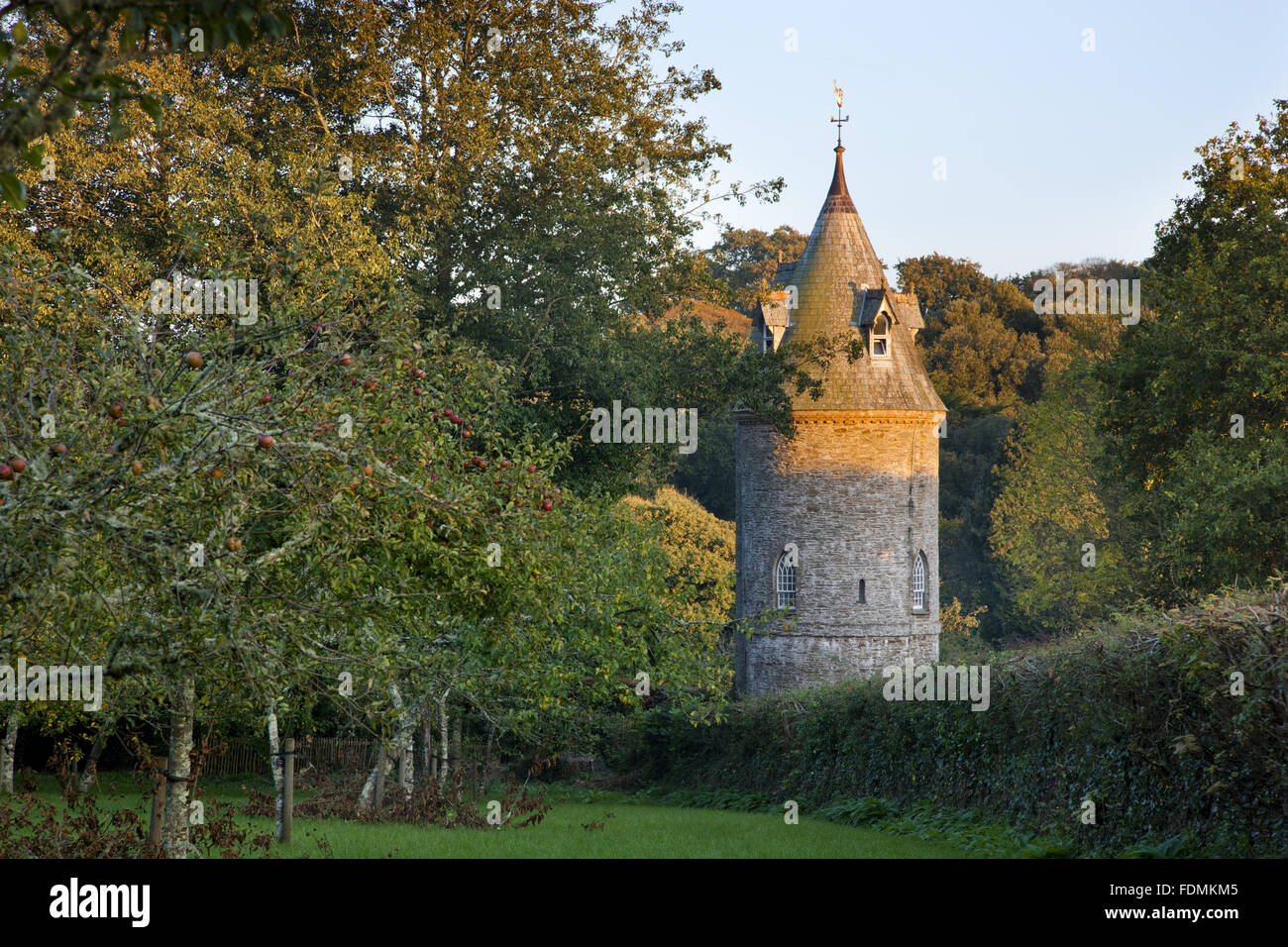 The Water Tower from the orchard at Trelissick Garden, Cornwall. The building was put up, probably in the 1820s, to provide water pressure for the house and garden. It is now a National Trust holiday cottage. Stock Photo