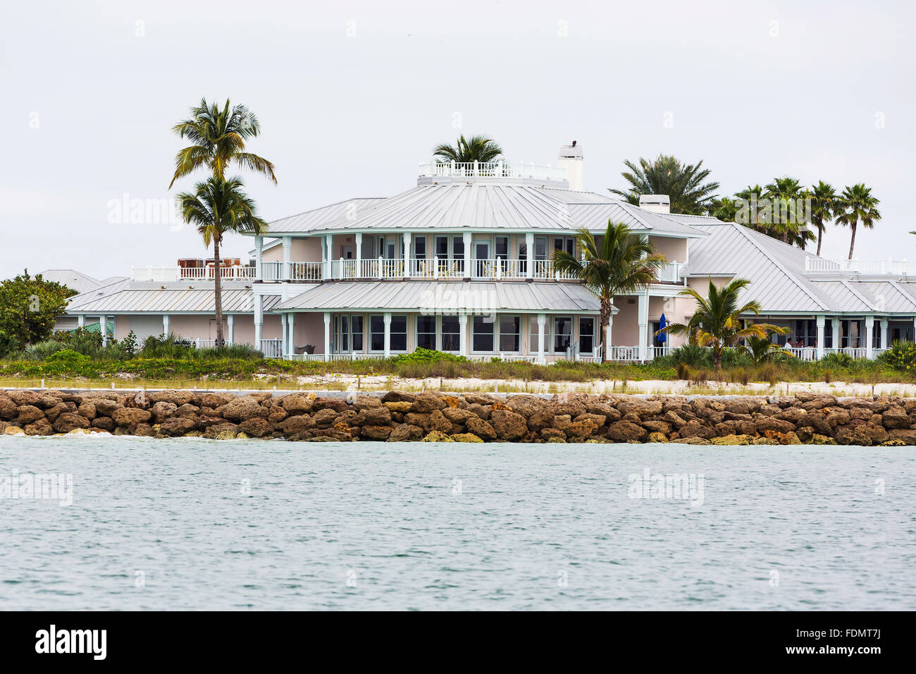 Luxury villa on Southwest Florida oceanfront garden with palm trees, tropical plants and flowers