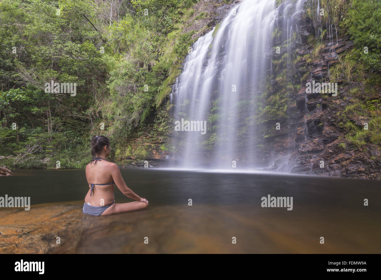 Tourist cooling down in Farofa Waterfall in the Serra do Cipo National Park Stock Photo