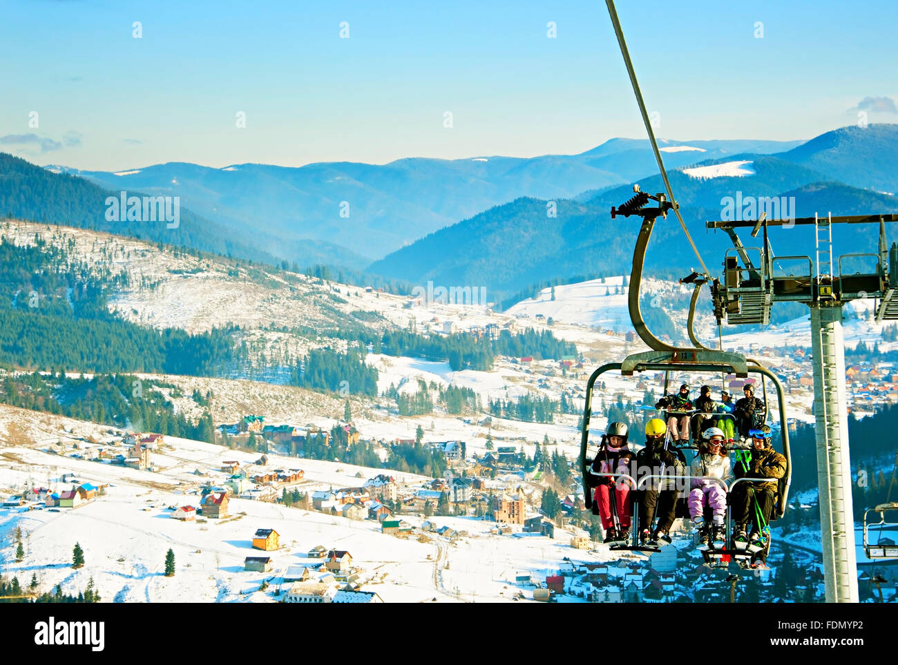 Skiers on a ski lift in Bukovel. Bukovel is the most popular ski resort in Ukraine. Stock Photo
