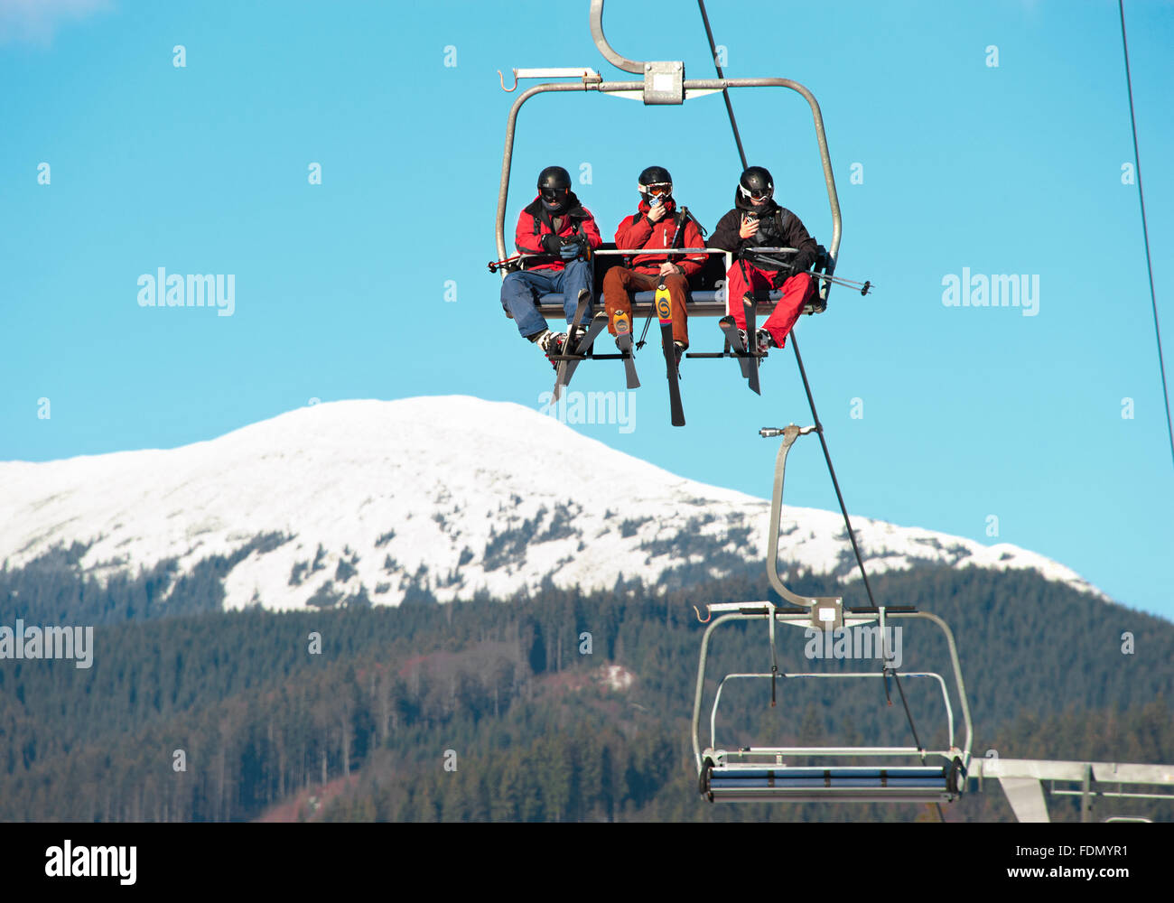 Skiers on a ski lift in Bukovel. Bukovel is the most famous ski resort in Ukraine. Stock Photo