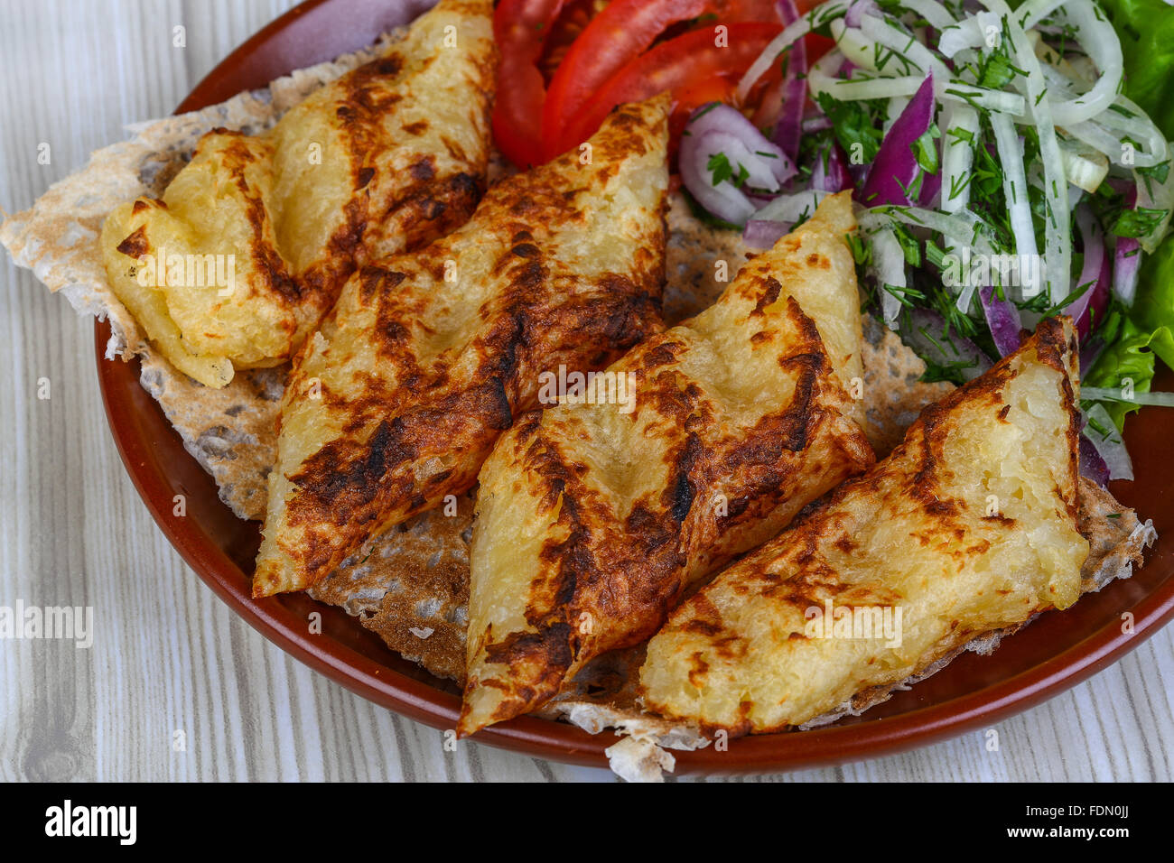 Grilled potato kebab served bread, tomato, salad and onion rings Stock
