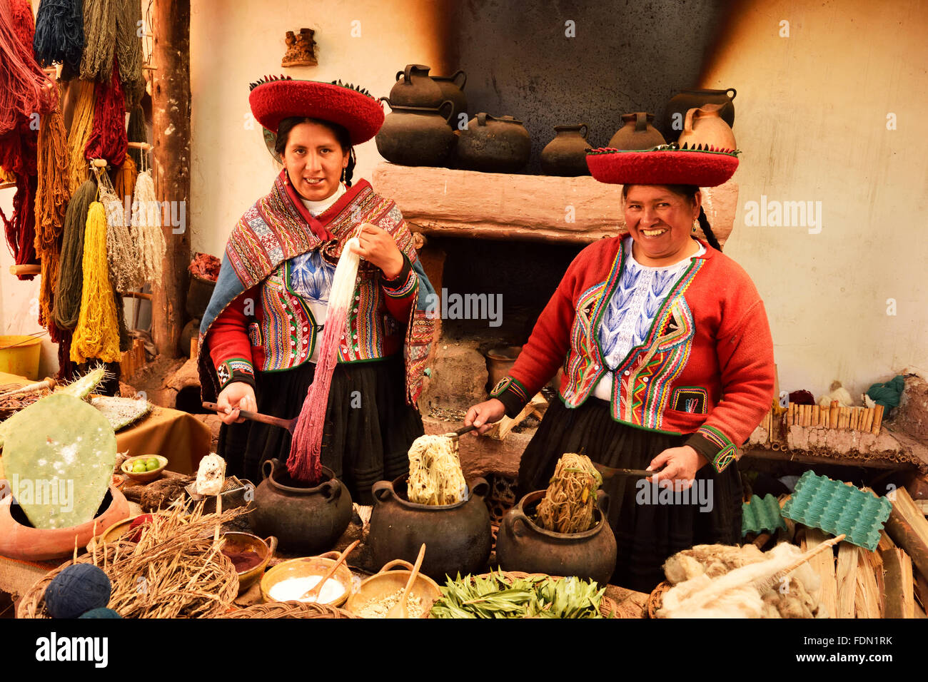 Two Peruvians, traditional alpaca wool dyeing, Chinchero, Cusco Province, Peru Stock Photo