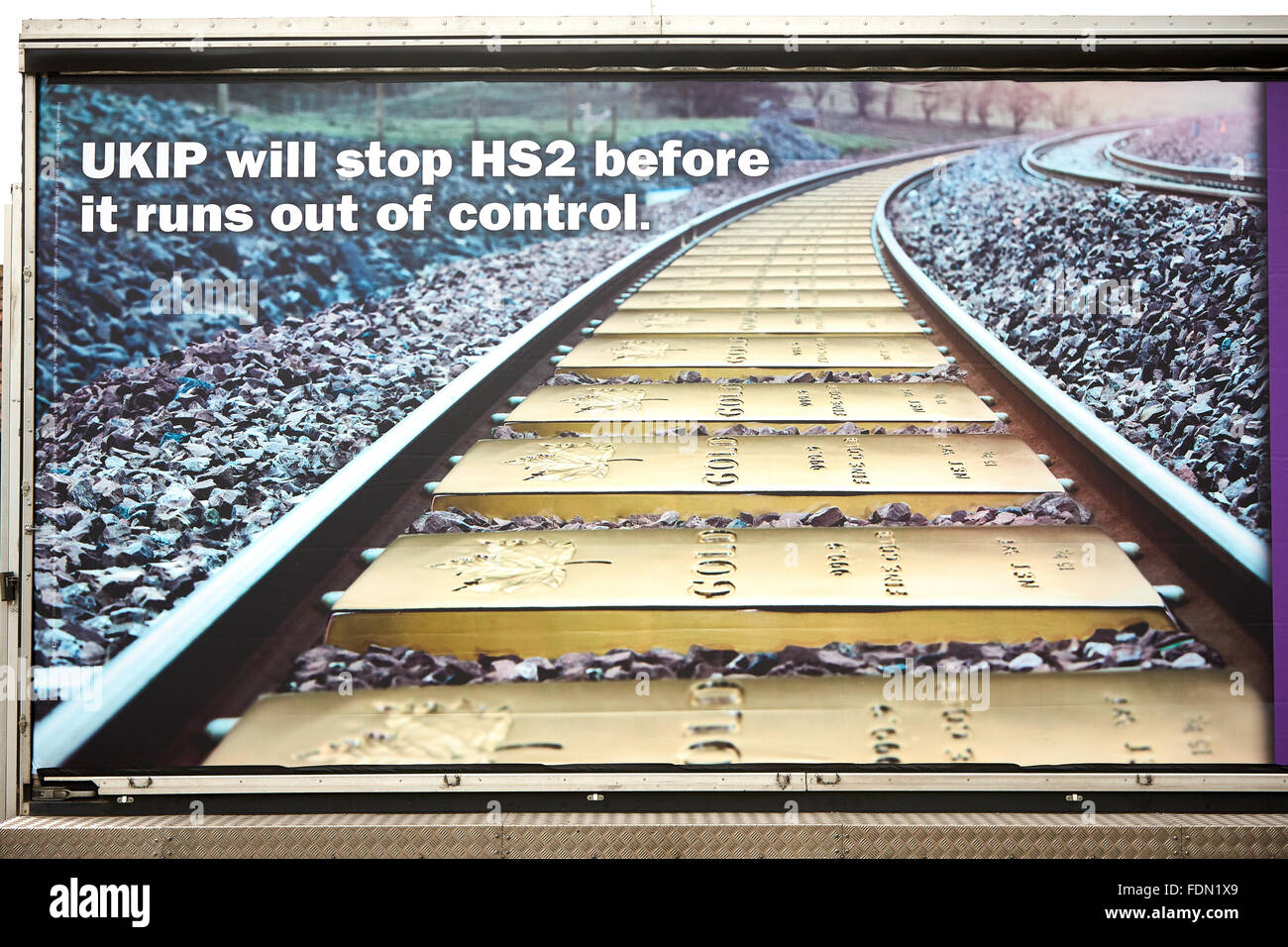 A UKIP anti-HS2 poster, featuring a track made of gold bars. Stock Photo