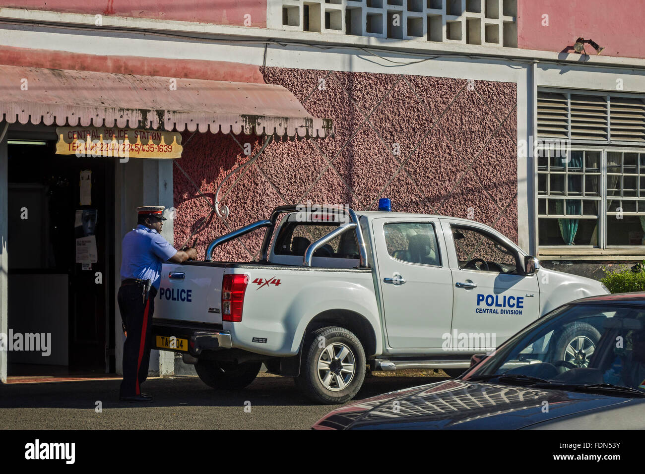 Police Officer and Vehicle St. Grenada West Indies Stock Photo