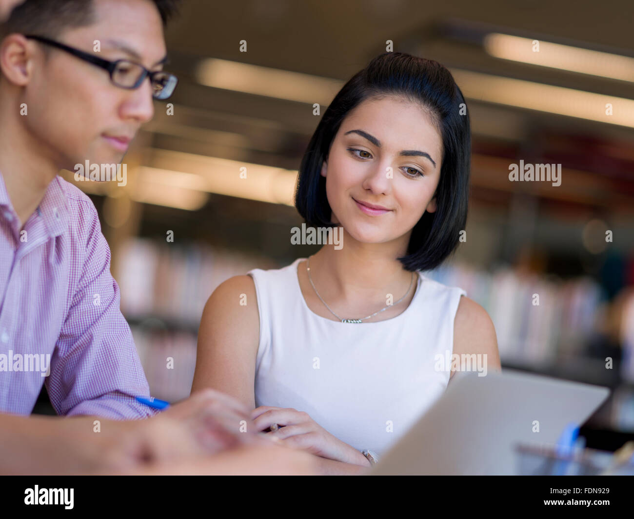 Group of young students working together at the library Stock Photo